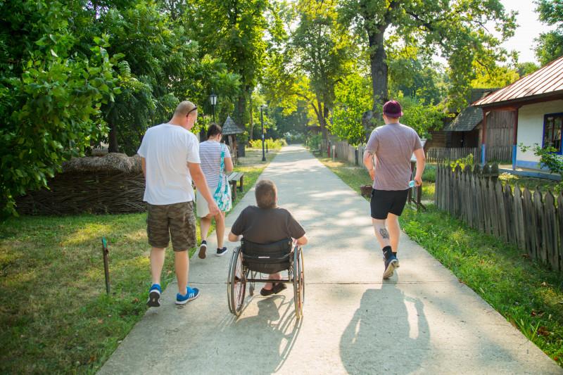 A wheelchair user explores Village Museum