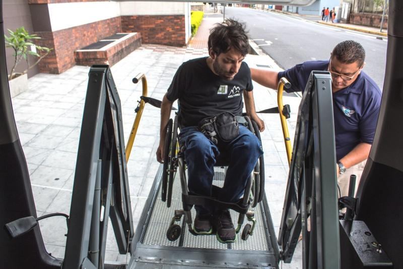 A wheelchair user accesses the van through the wheelchair lift
