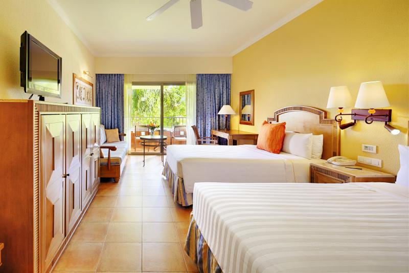 Hotel Superior Room has smooth tile floors, a large bed, and a private patio space.