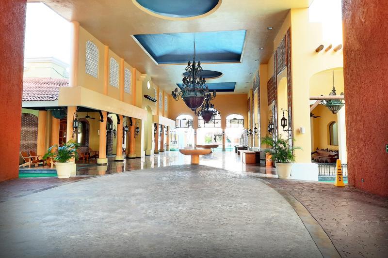 Spacious lobby and entry area with spanish theme, ramps, and seating areas