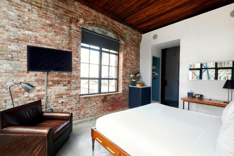 Guestroom with exposed brick wall and modern decor.