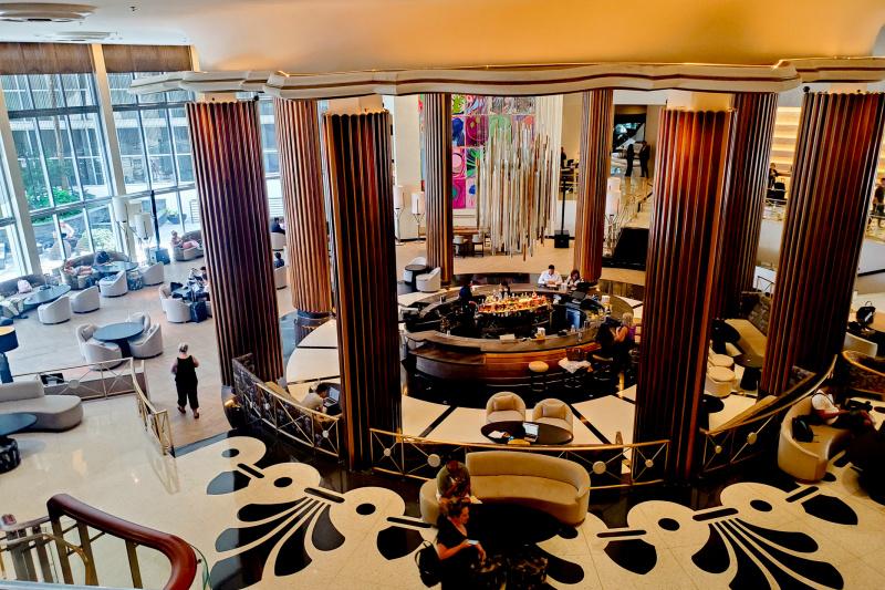 The hotel lobby has a central bar surrounded by pillars and plenty of comfortable seating.