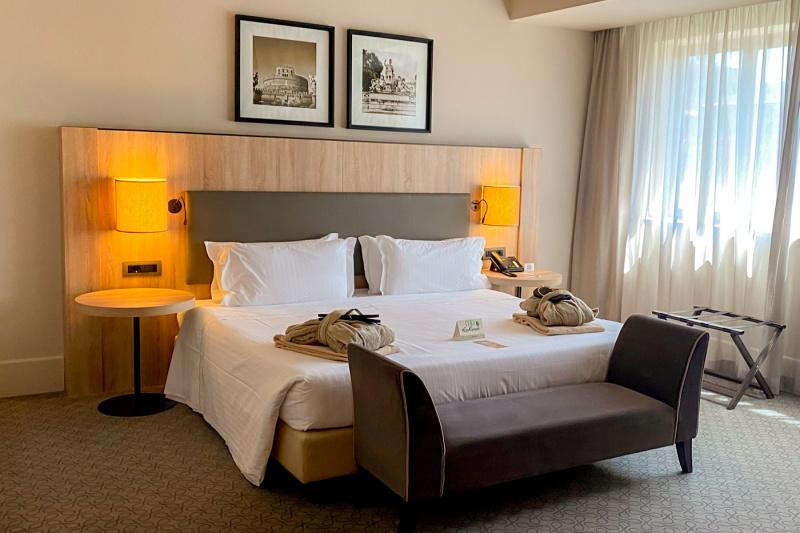 The Junior suite has an extra large double bed with reading lights, side tables, a telephone, robes, slippers, framed antique photographs, a plush ottoman and a suitcase stand.