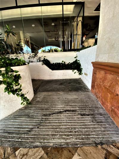 The outdoor ramp leads down to another level of the hotel. There are no handrails