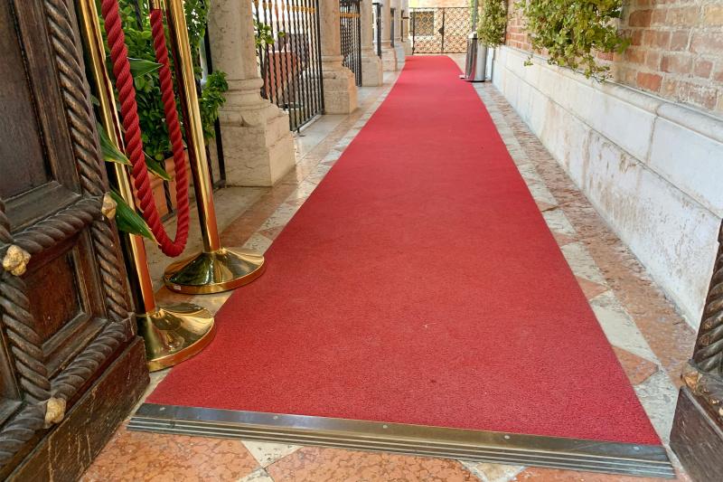 Exterior entrance with red carpet and double doors
