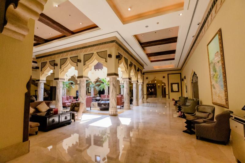 Sharq Village & Spa lobby with opulant marble furnishings and columns and smooth marble floors