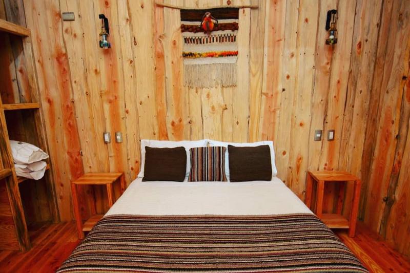 A queen size bed in the cabin.