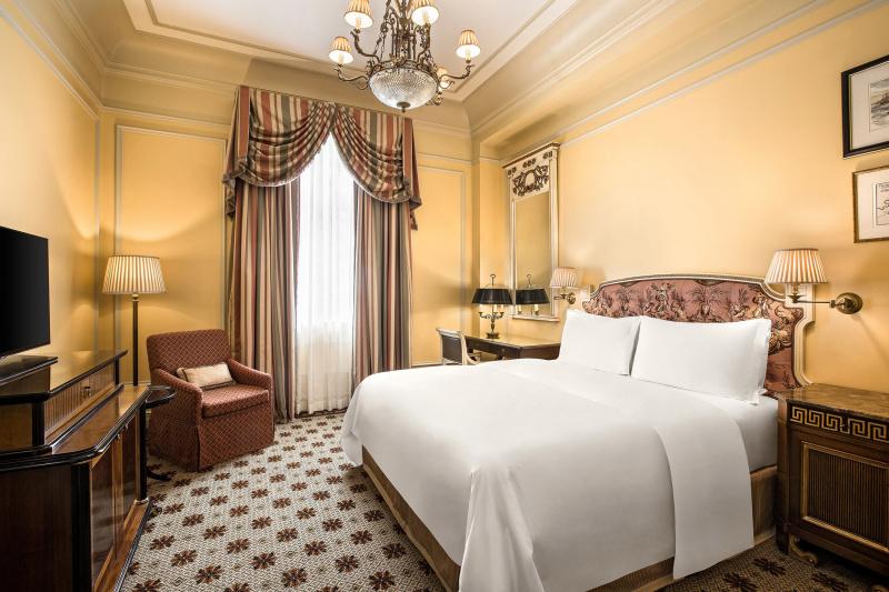 A luxurious guest room decorated in a classical style.