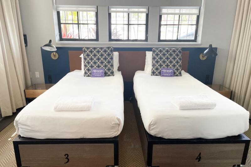 An accessible guest room with twin beds and bedside tables.