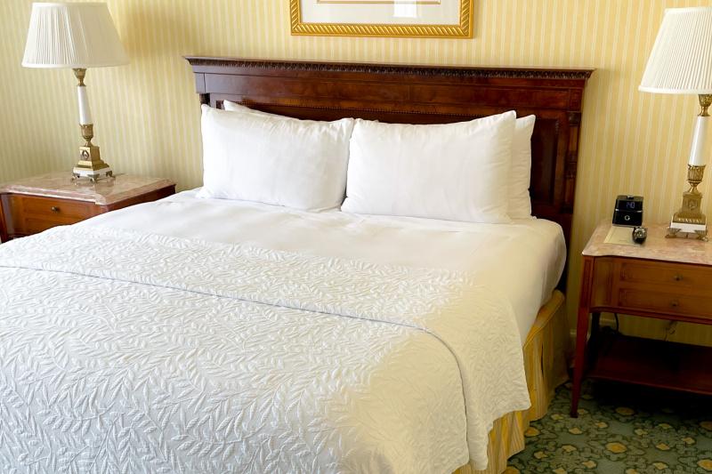 The accessible guest room, with a king-sized bed, carpeted floor and bedside tables.