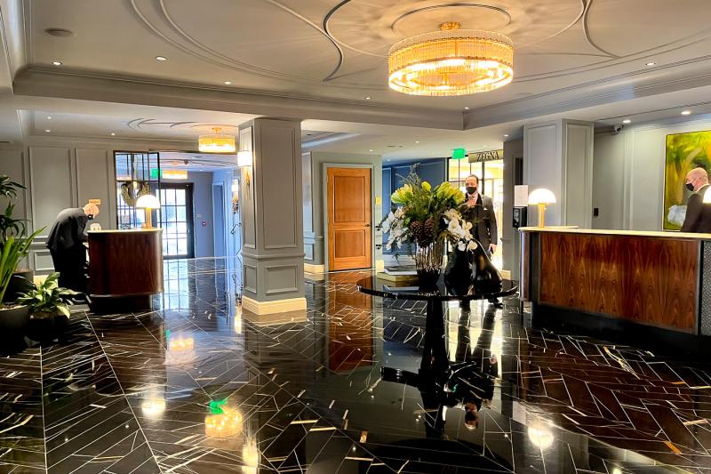 Entrance to lobby with marble floor and modern artwork