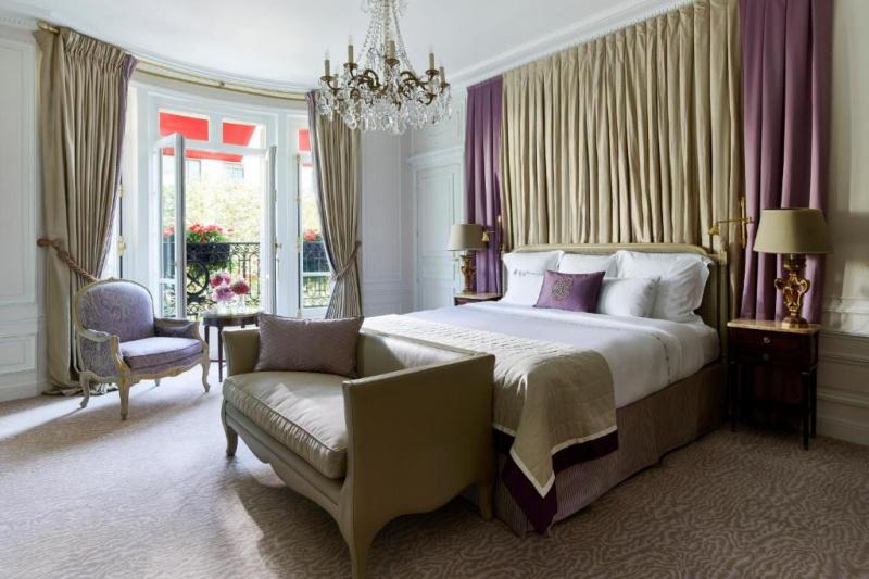 Guestroom with luxury decor and chandelier.