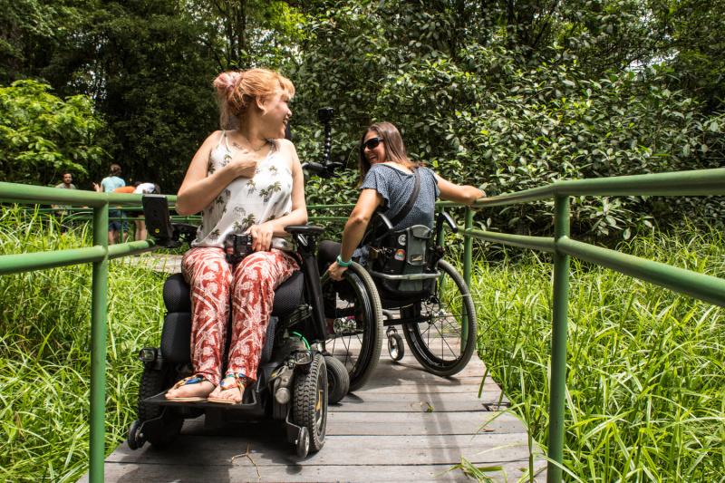 Wheel the World travelers cross on accessible park path