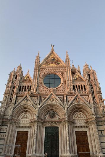 Piazza del Duomo with towering exterior and ornate design features