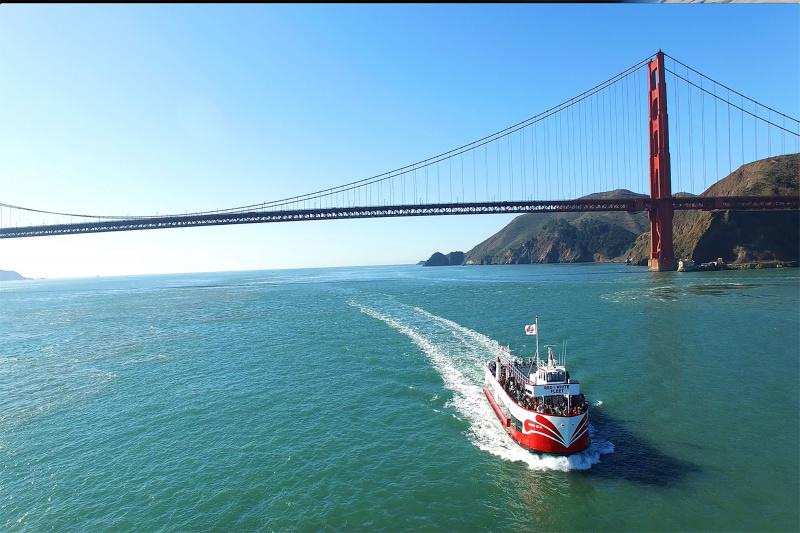 A boat returns after passing under the Golden Gate Bridge