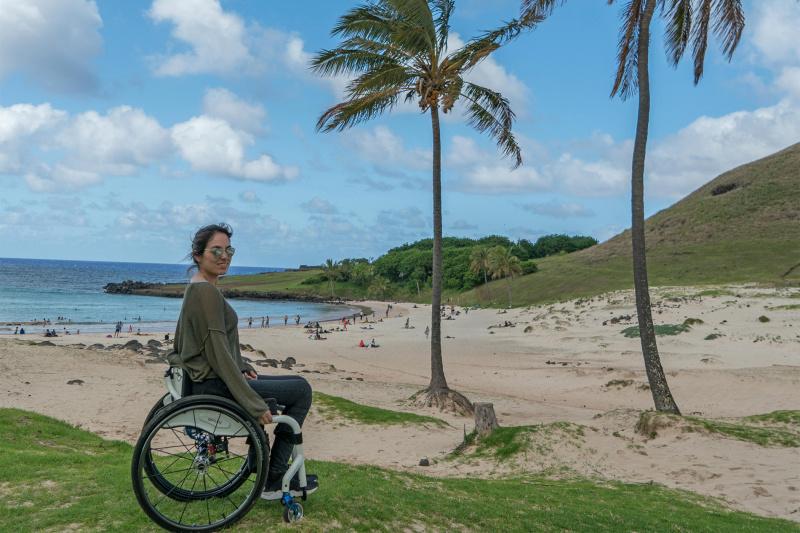 A woman in a wheelchair on Anakena Beach