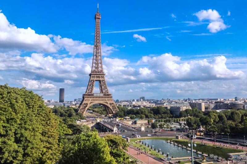 The Eiffel Tower, seen on a clear day with blue skies.