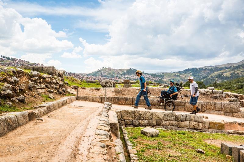 A group of friends traverse Cusco lands using a joëlette wheelchair